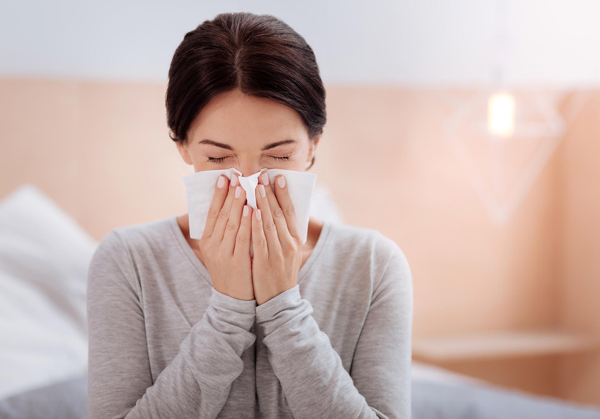 Woman sneezing with respiratory issues